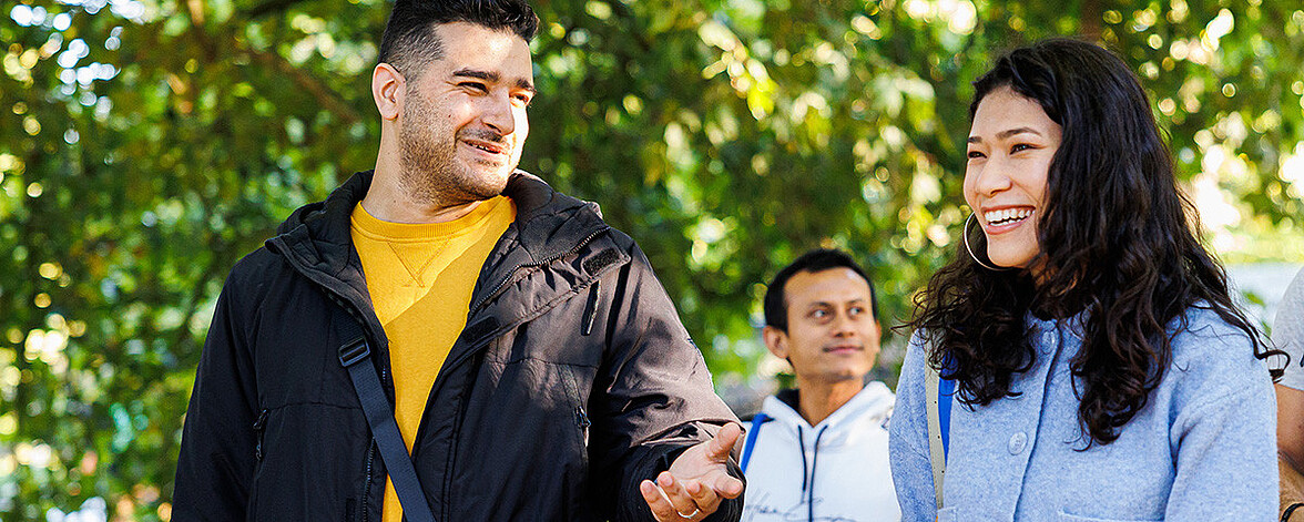 Two international students in a conversation on campus.
