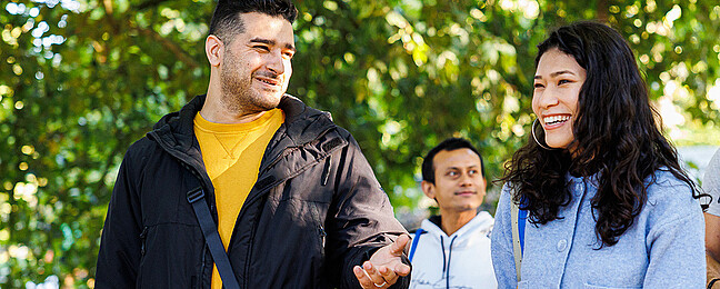 Two international students in a conversation on campus.